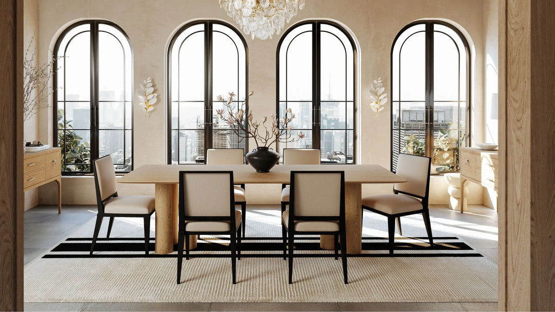 Cream and black dining chairs around a 6 seater dining table in a light airy room