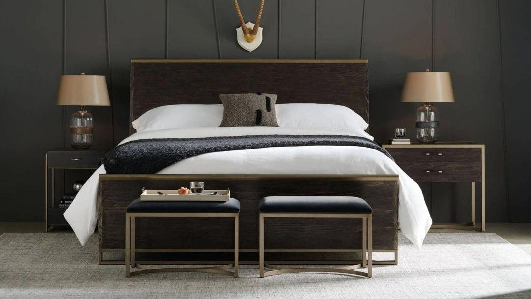 Black bedroom setting with black upholstered bed in the centre with two matching bedside tables either side 