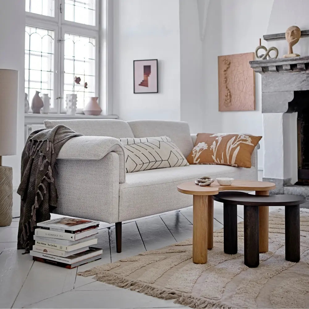 Modern living room with a gray sofa, wooden coffee table, and decorative items.