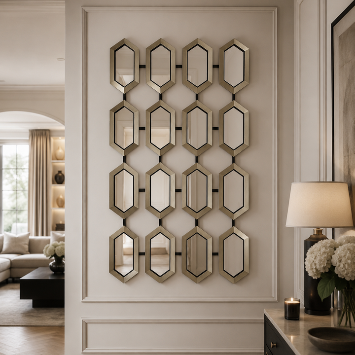 A decorative wall mirror arrangement featuring 12 hexagonal mirrors with brushed gold frames, mounted on a white paneled wall in a modern, elegant interior hallway.