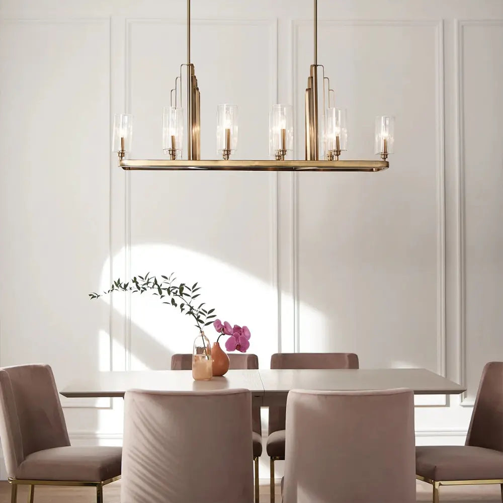 Modern dining room with a chandelier, table, and chairs.