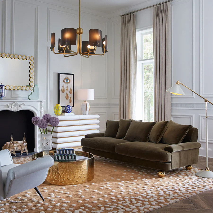 Luxurious living room with a brown sofa, gold coffee table, and decorative elements.