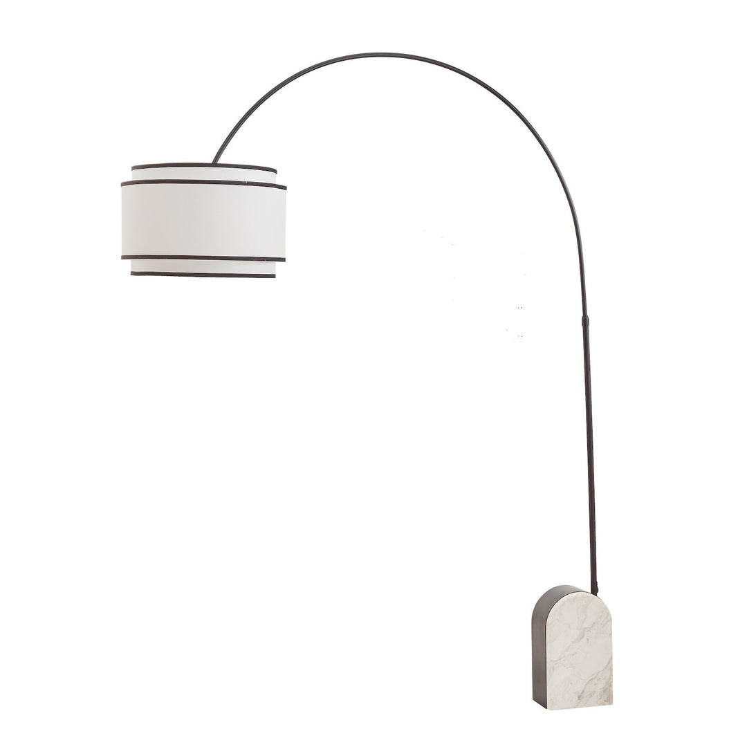 Curved floor lamp with marble base and white shade with black contrast piping on a white background