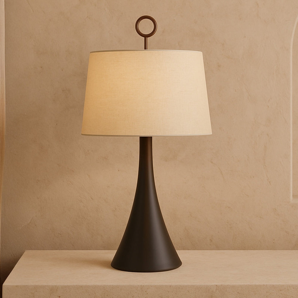 Wooden base table lamp with neutral linen shade on a neutral background