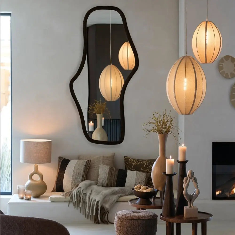 Modern scandi interior with pendant lights and wavy black mirror. 