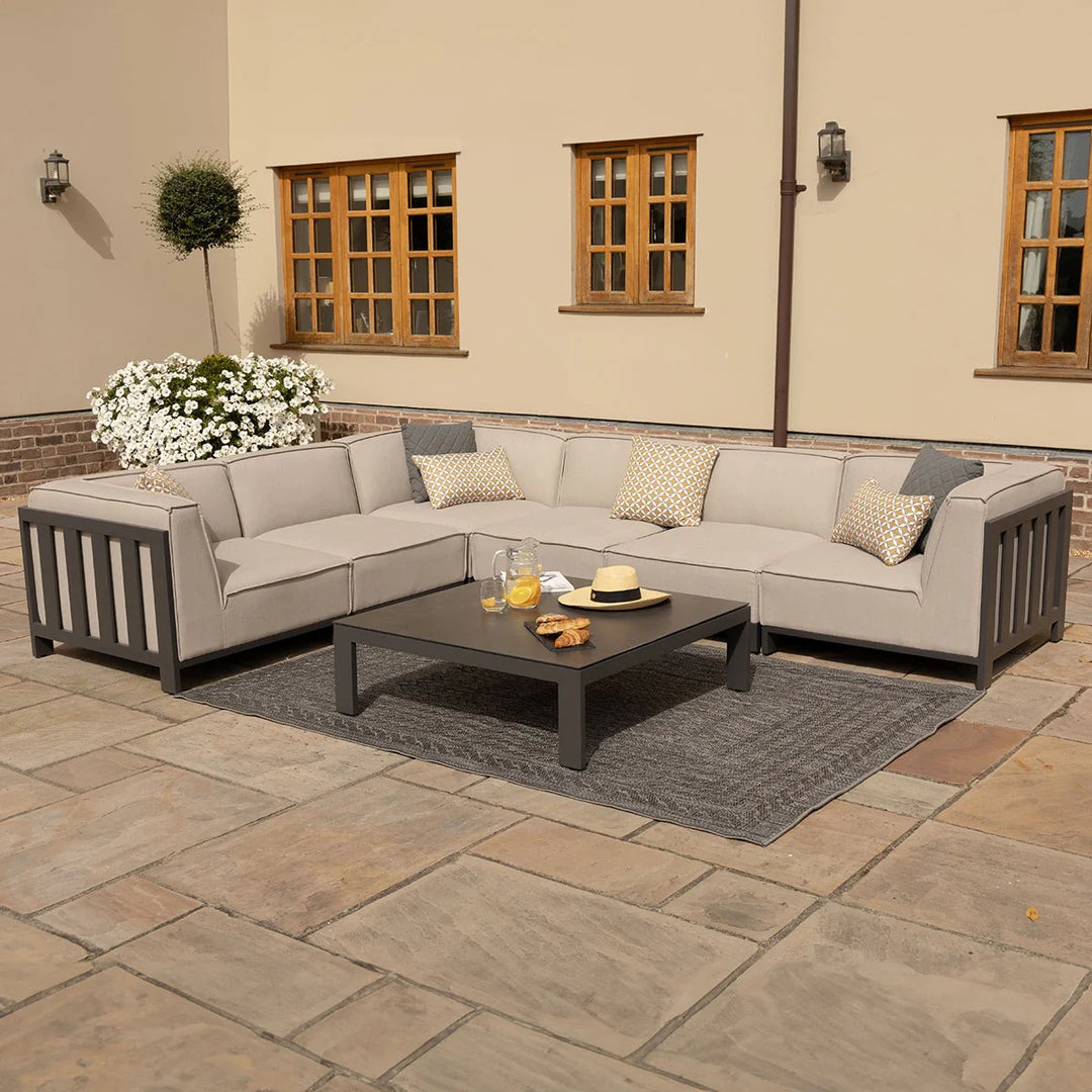 Outdoor patio sectional with coffee table on a stone patio