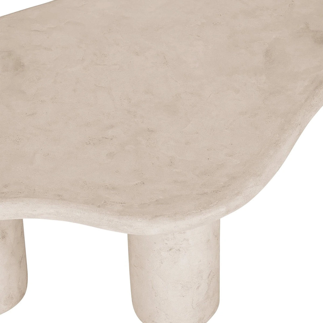 Close-up of a beige stone surface with a subtle texture on a white background