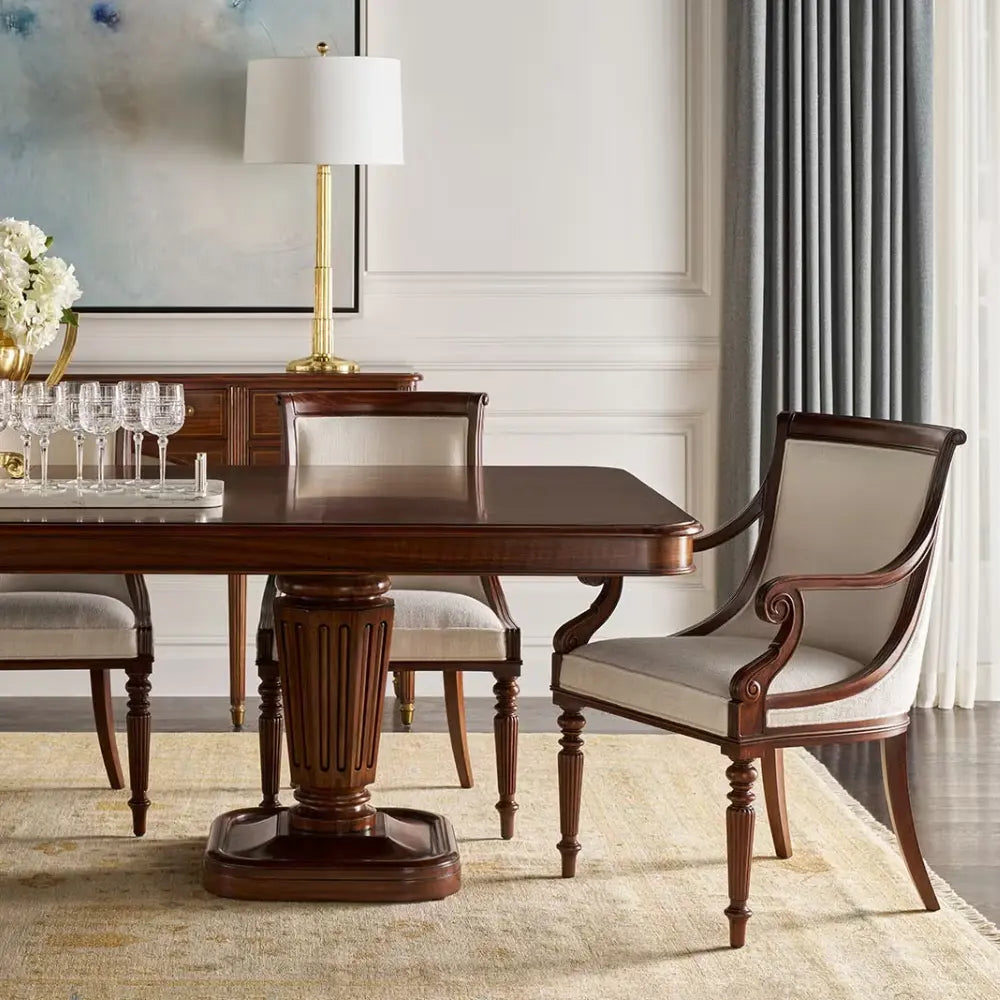 Dining room with wooden table and chairs in a well-lit room.