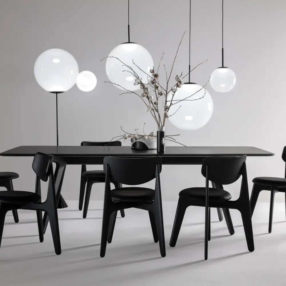 Modern black dining table image with white globe lighting 