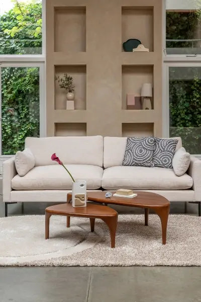 Beige sofa with decorative pillows in a living room setting