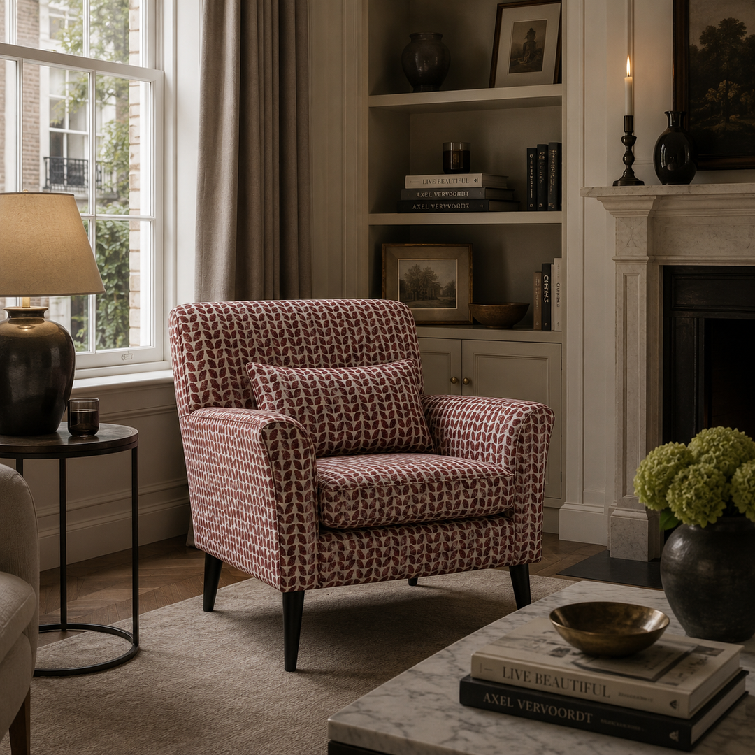 Patterned armchair in a living room with a fireplace and bookshelf.