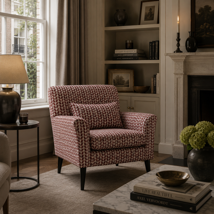 Patterned armchair in a living room with a fireplace and bookshelf.