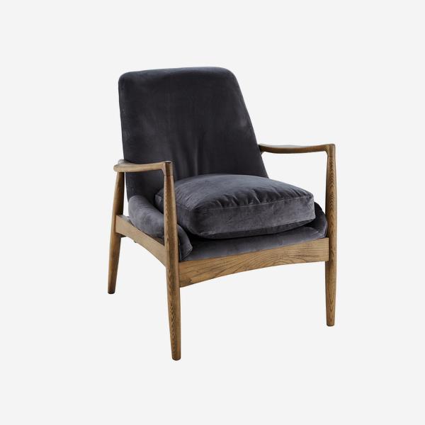 grey velvet chair in a rich dark wooden frame which is  naturally decorated with wood grainin